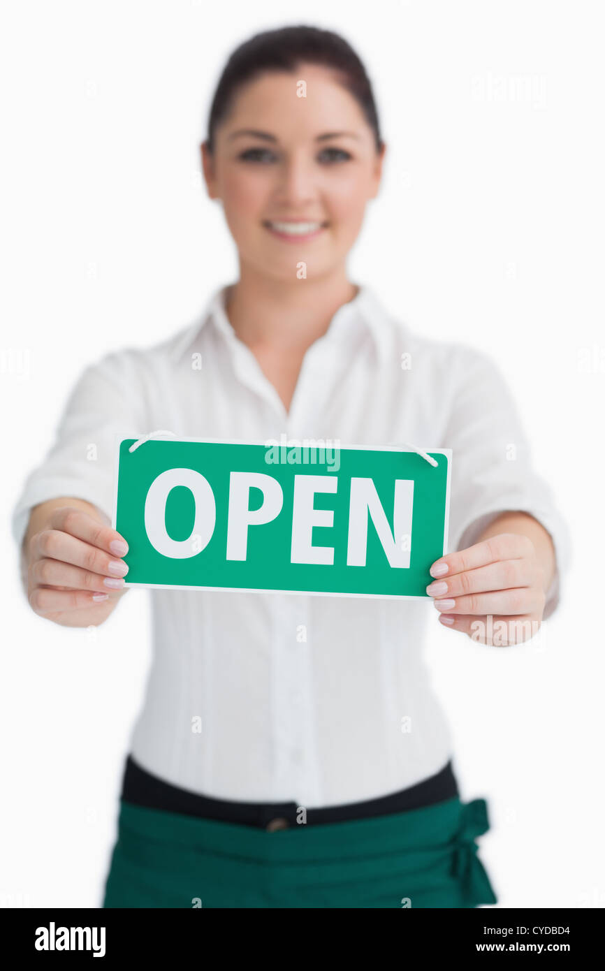 Waitress holding out open sign Stock Photo