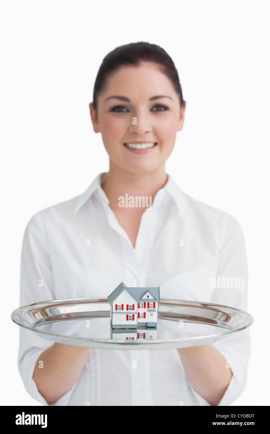 Waitress holding a little house Stock Photo