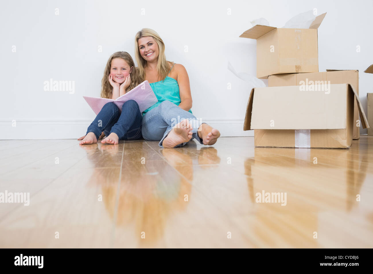 Mother and daughter reading a book together Stock Photo