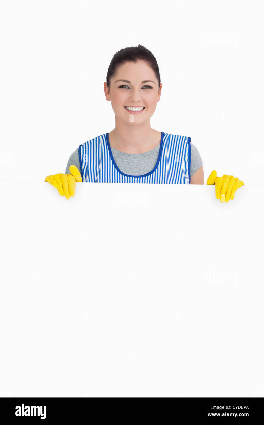 Cleaning woman showing a white panel Stock Photo