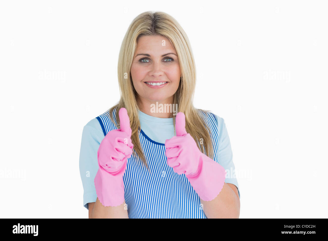 Smiling cleaner putting thumbs up with pink gloves Stock Photo