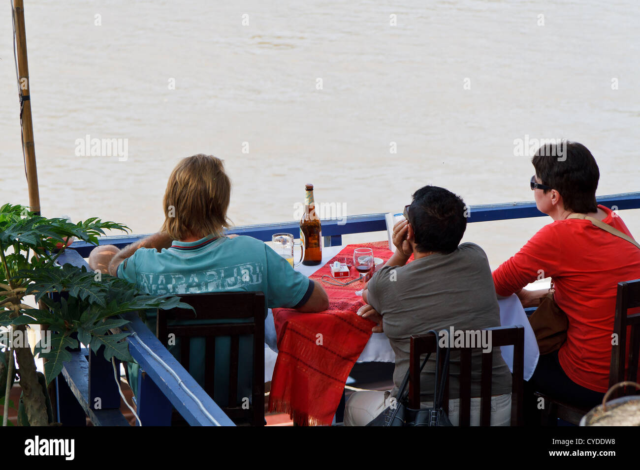 Tourists enjoying the View onto the River Mekong in Luang Prabang, Laos Stock Photo