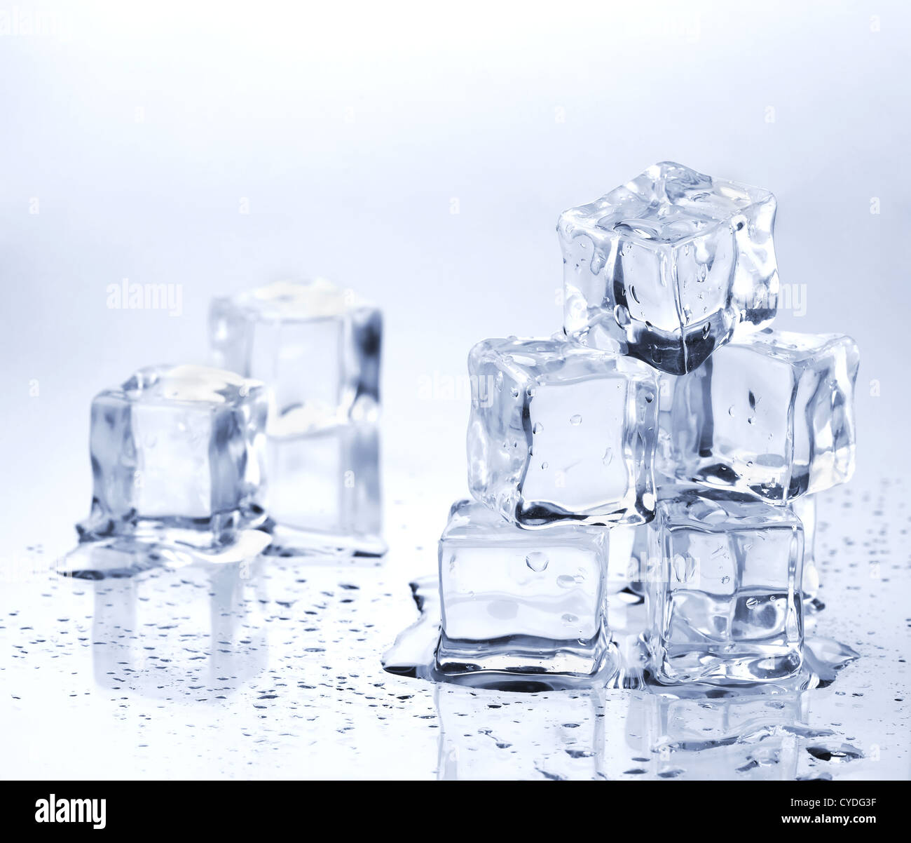 Square melting ice cubes on wet table Stock Photo by FabrikaPhoto