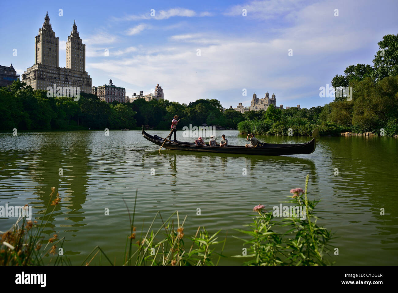 A family rides a gondola in New York City's Central Park pond. © Craig