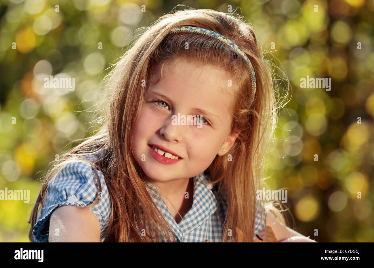Portrait of a young girl in a park Stock Photo - Alamy