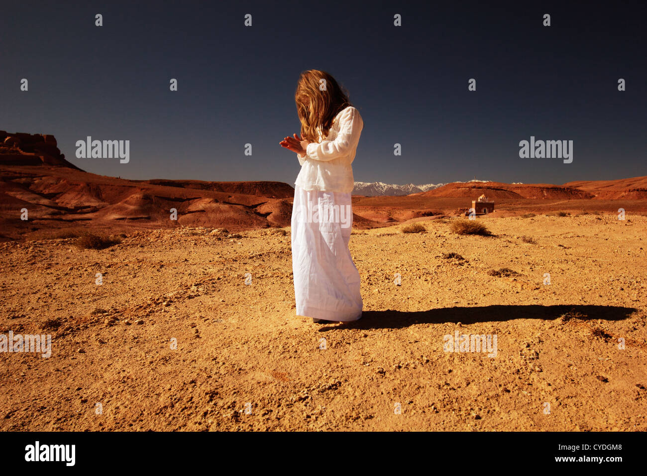 Young girl dressed all in white in the desert of Morocco. Stock Photo