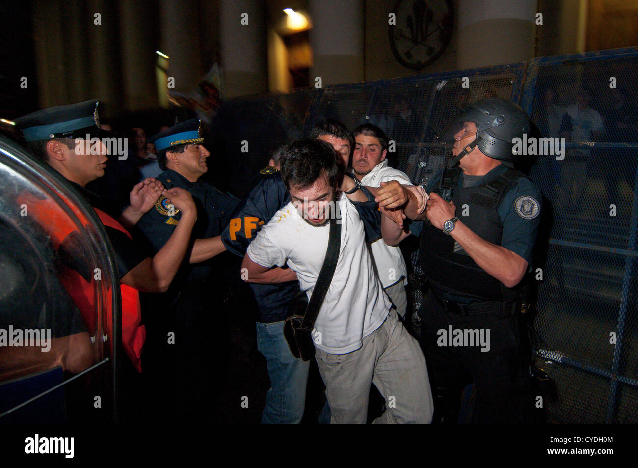 Nov. 1, 2012 - Buenos Aires, Argentina - An anti-abortion demonstrator attacks a pro-abortion activist as he is arrested by the Police. Groups of pro-abortion demonstrators clashed with the police after several thousands rallied from Congress to the Cathedral in Buenos Aires. At the Cathedral, guarded by Catholic anti-abortion activists, a Police operation was set up to prevent clashes among the two opposite groups. Pro Abortion demonstrators demand the immediate discussion in Congress of the law that would allow legal, free and safe abortions in public hospitals, to which Catholics oppose. Il Stock Photo