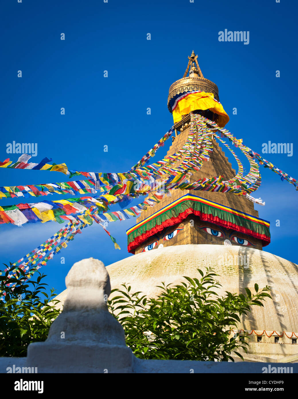 Buddhist Shrine Boudhanath Stupa with pray flags over blue sky. Nepal, Kathmandu Stock Photo