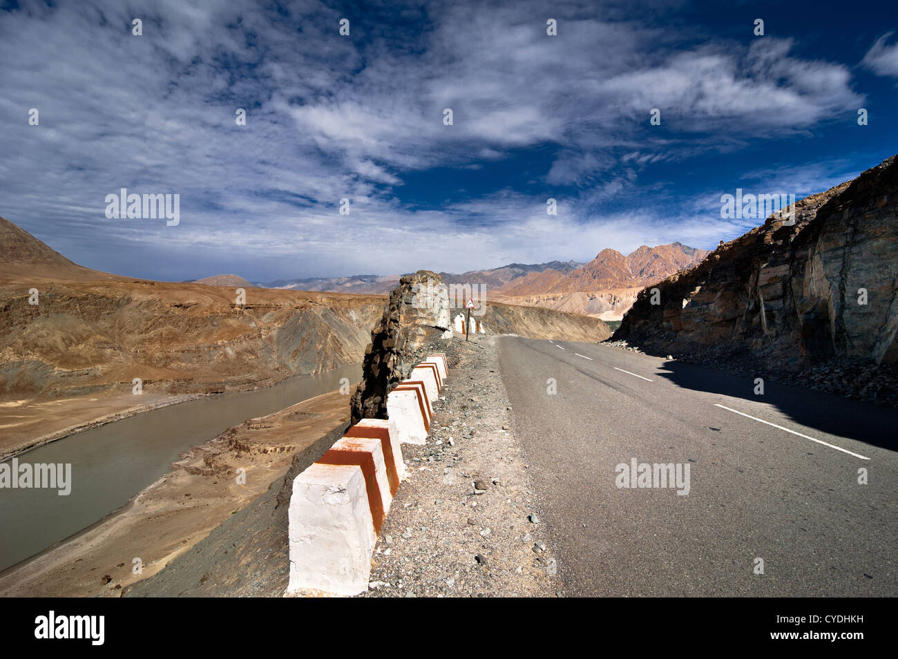 Road going across Himalaya mountains along Indus river under blue cloudy sky. India, Ladakh, altitude 3300 m Stock Photo