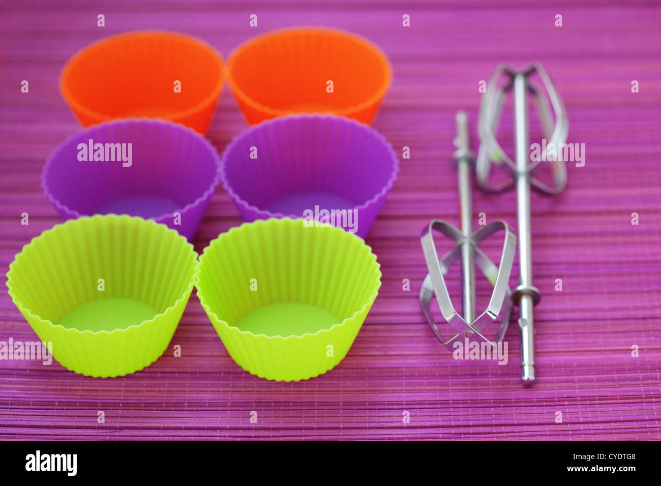 Colorful silicone baking cups on purple background Stock Photo