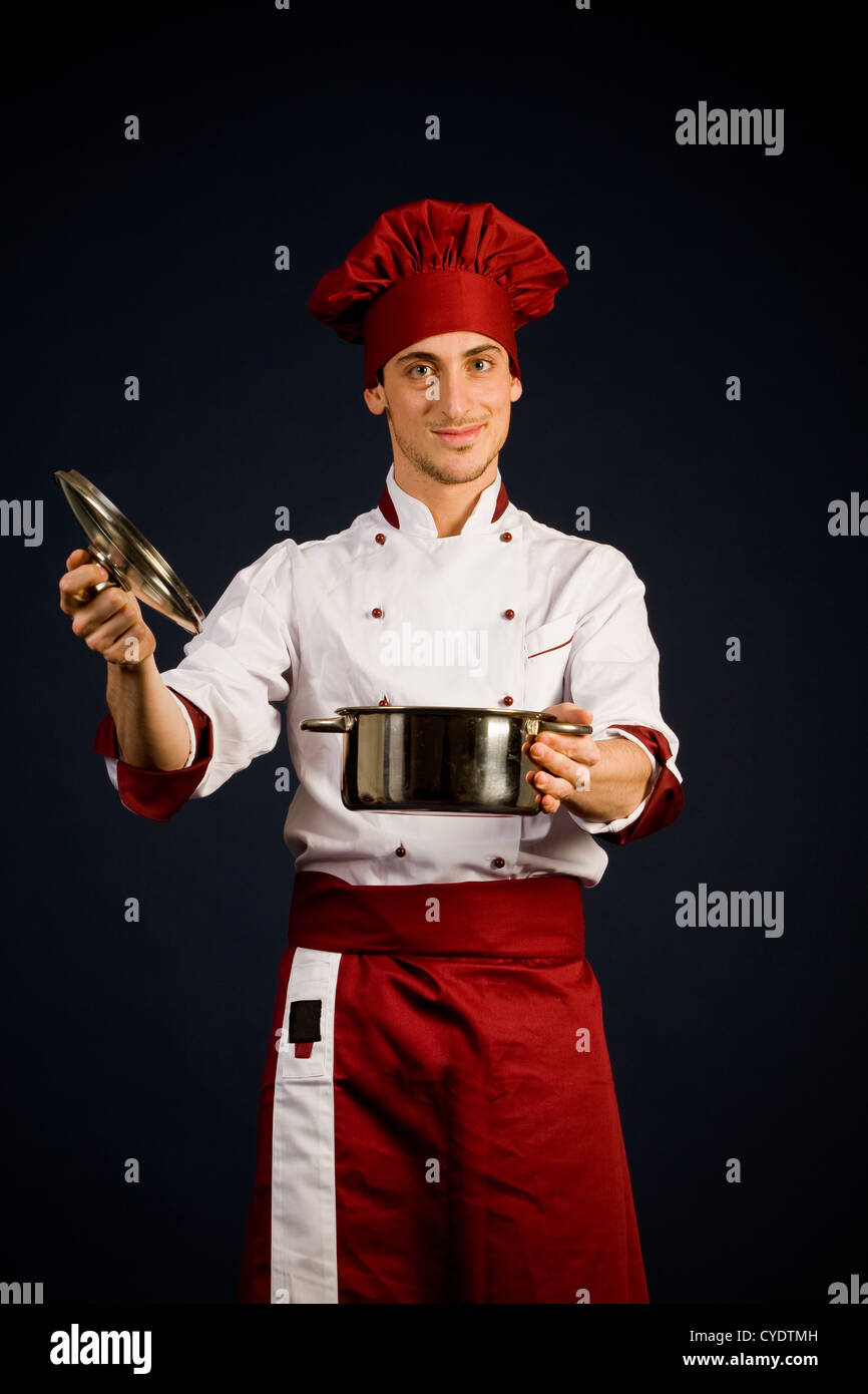 Chef Using Pot photo of young male chef holding a pot in front of a blue background ...