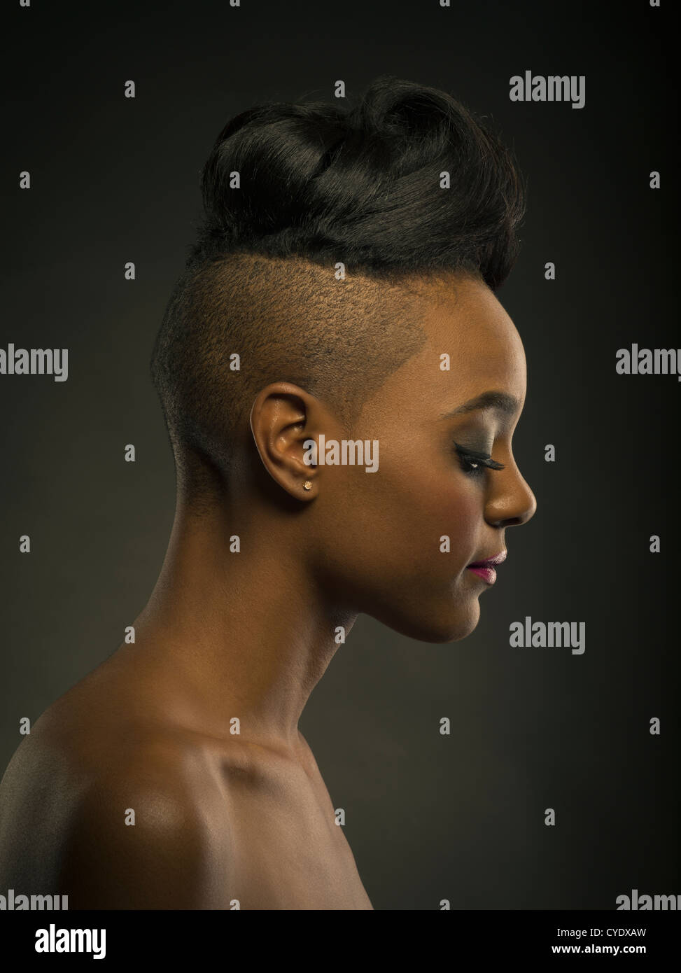 Woman with stylish haircut -  head shaved at sides and long hair on top. Stock Photo
