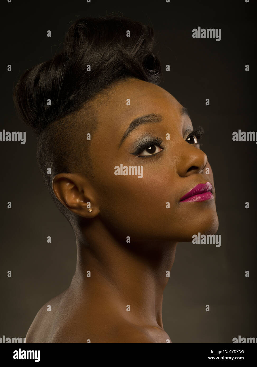 Woman with stylish haircut -  head shaved at sides and long hair on top. Stock Photo