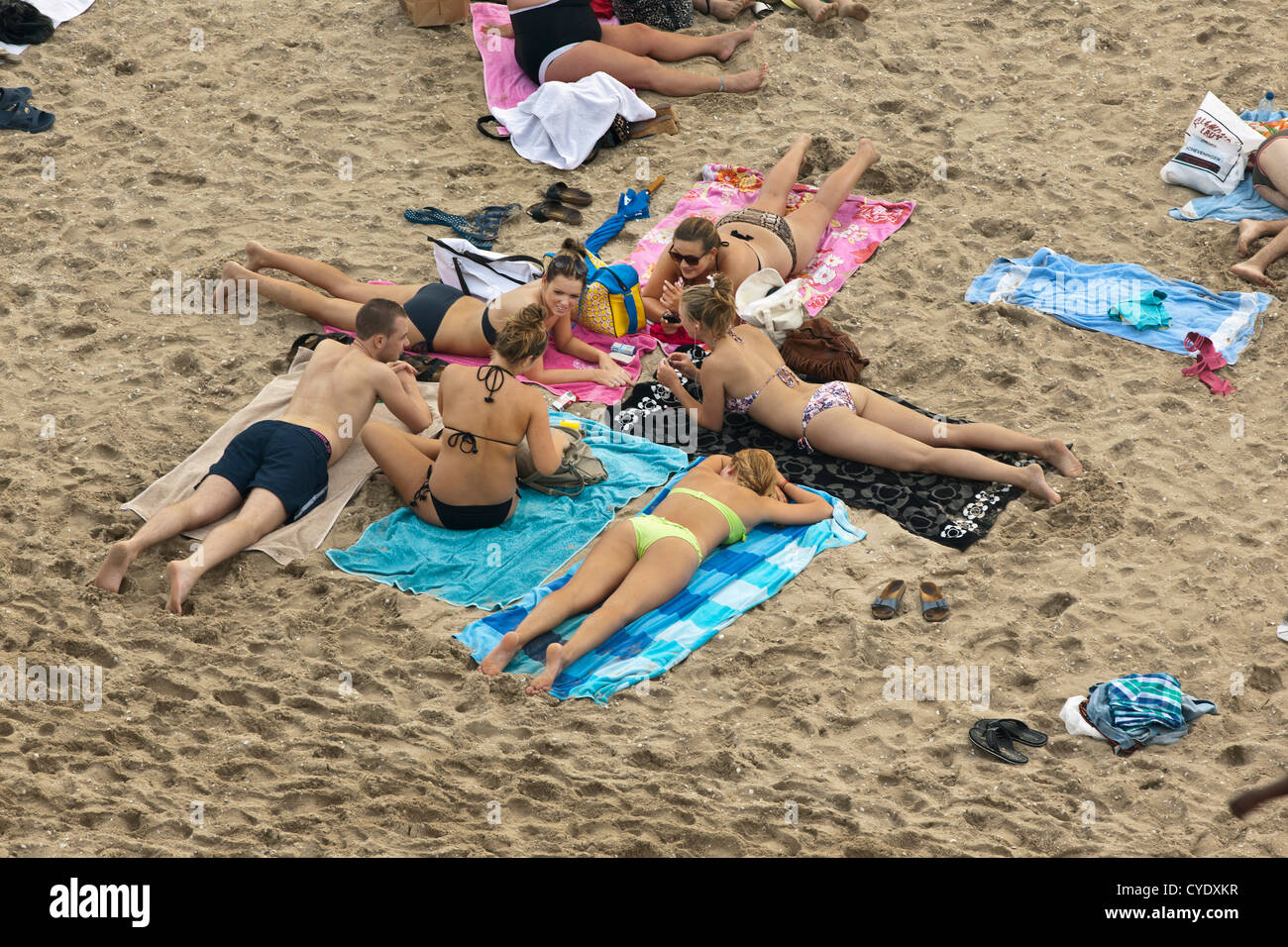 The Netherlands, Scheveningen, near The Hague or in Dutch: Den Haag. Young people sunbathing on the beach. Aerial Stock Photo