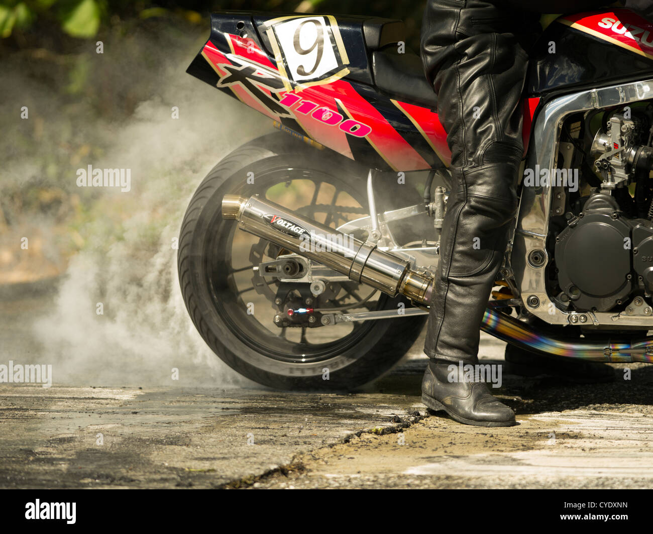 Motorbike smoking rear tire burnout. Stock Photo