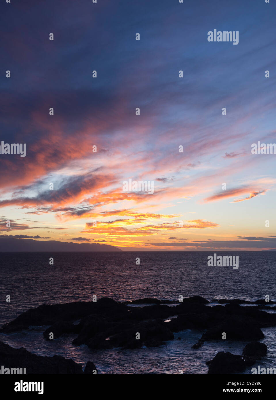 Twilight sky west of Tenerife with red and yellow and purple coloring Stock Photo
