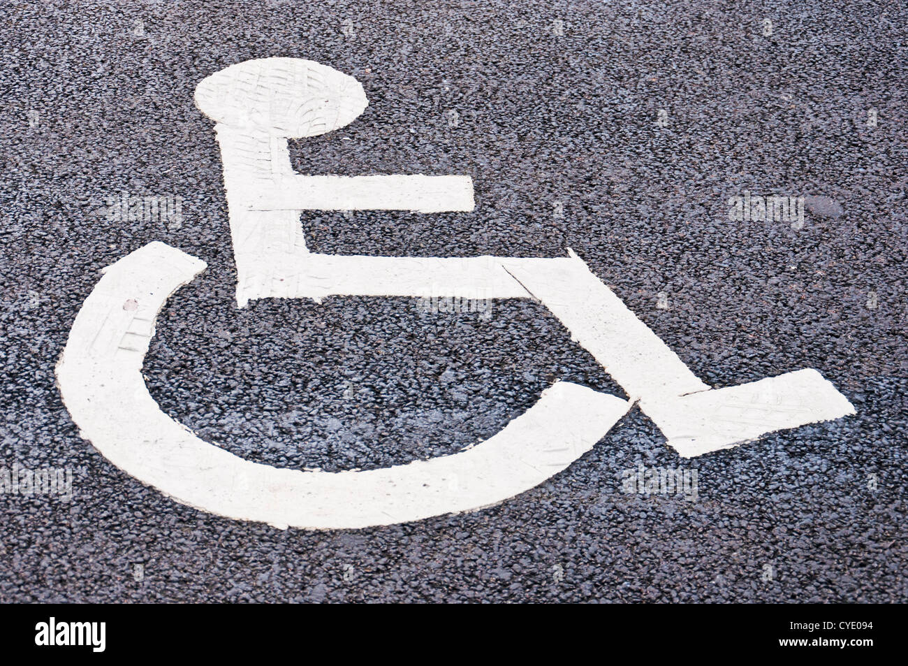 Disabled person sign painted on tarmac to show area of disabled parking Stock Photo