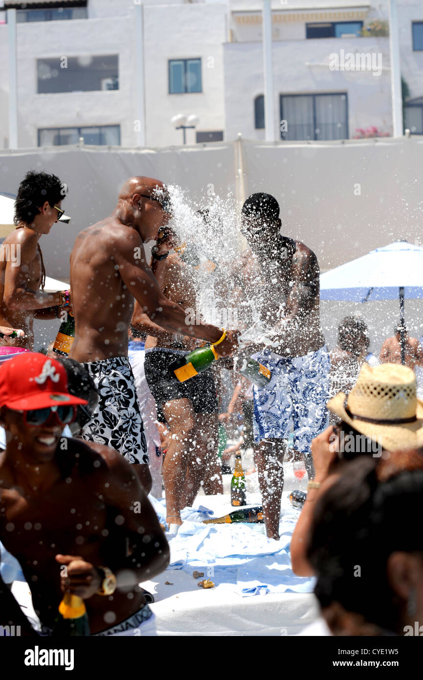 British holiday makers spraying champagne all over each other at the annual Ocean Club Champagne spray party in Puerto Banus, Stock Photo