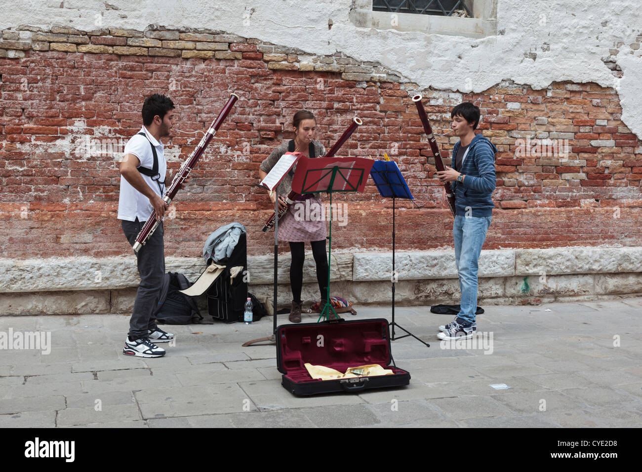 Music students playing classical instruments in a Venice street in the Academia district on a Sunday afternoon Stock Photo