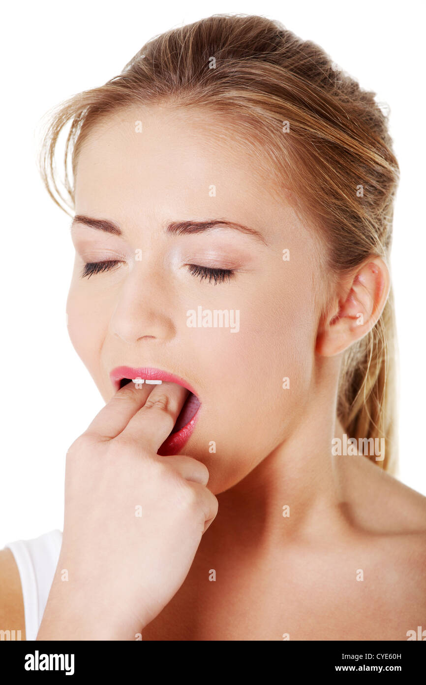 Teen girl putting her finger in her mouth to provoke vomiting Stock Photo