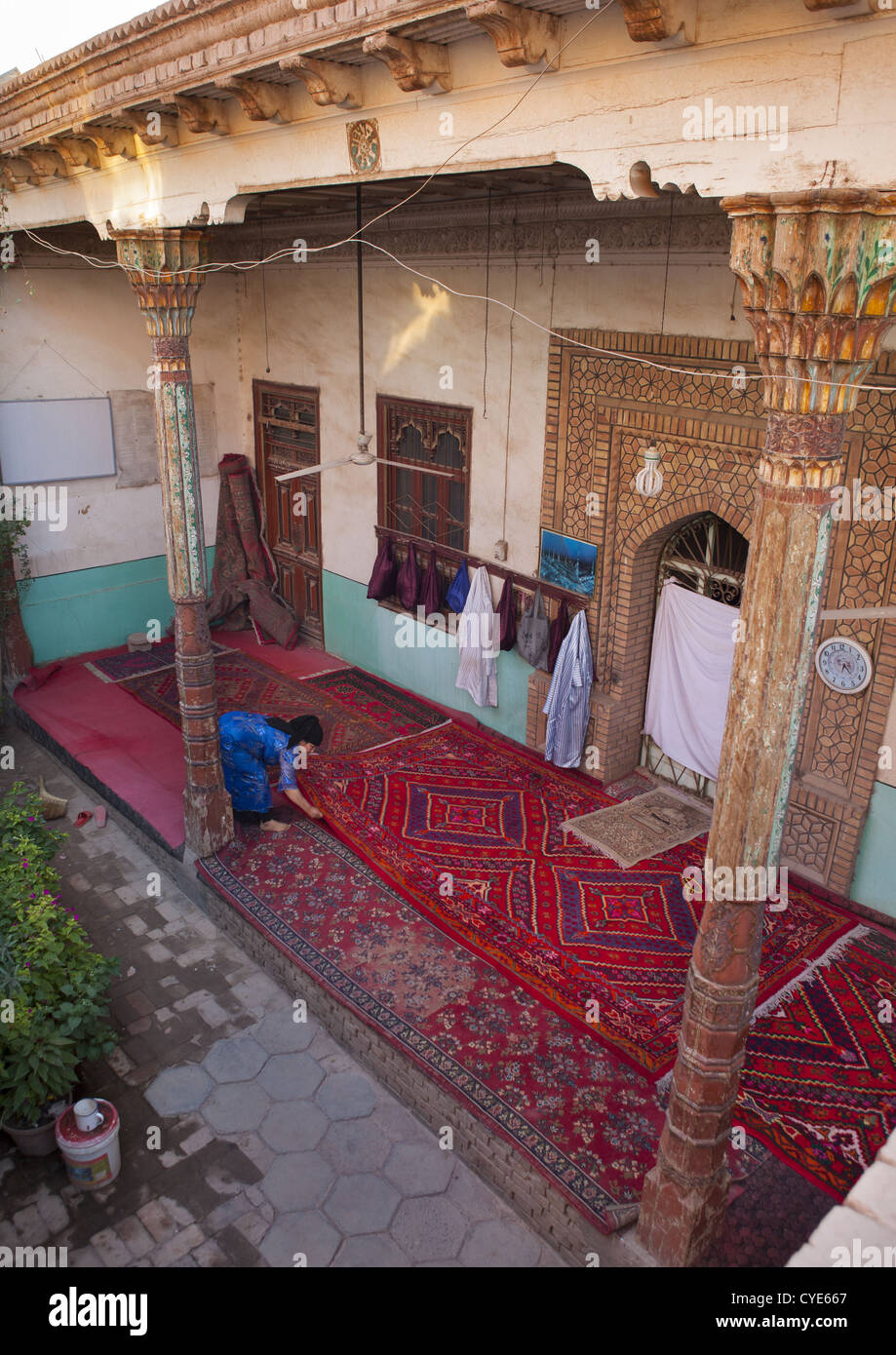 Uygur Woman Uncoiling The Carpets Of A Mosque, Old Town Of Kashgar, Xinjiang  Uyghur Autonomous Region, China Stock Photo - Alamy