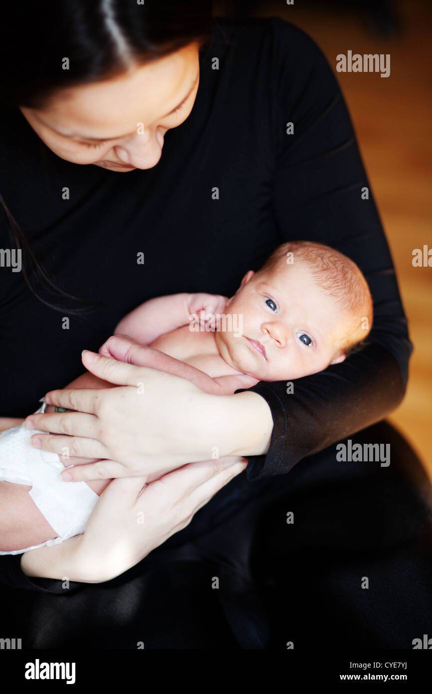 Newborn baby on mother hands Stock Photo
