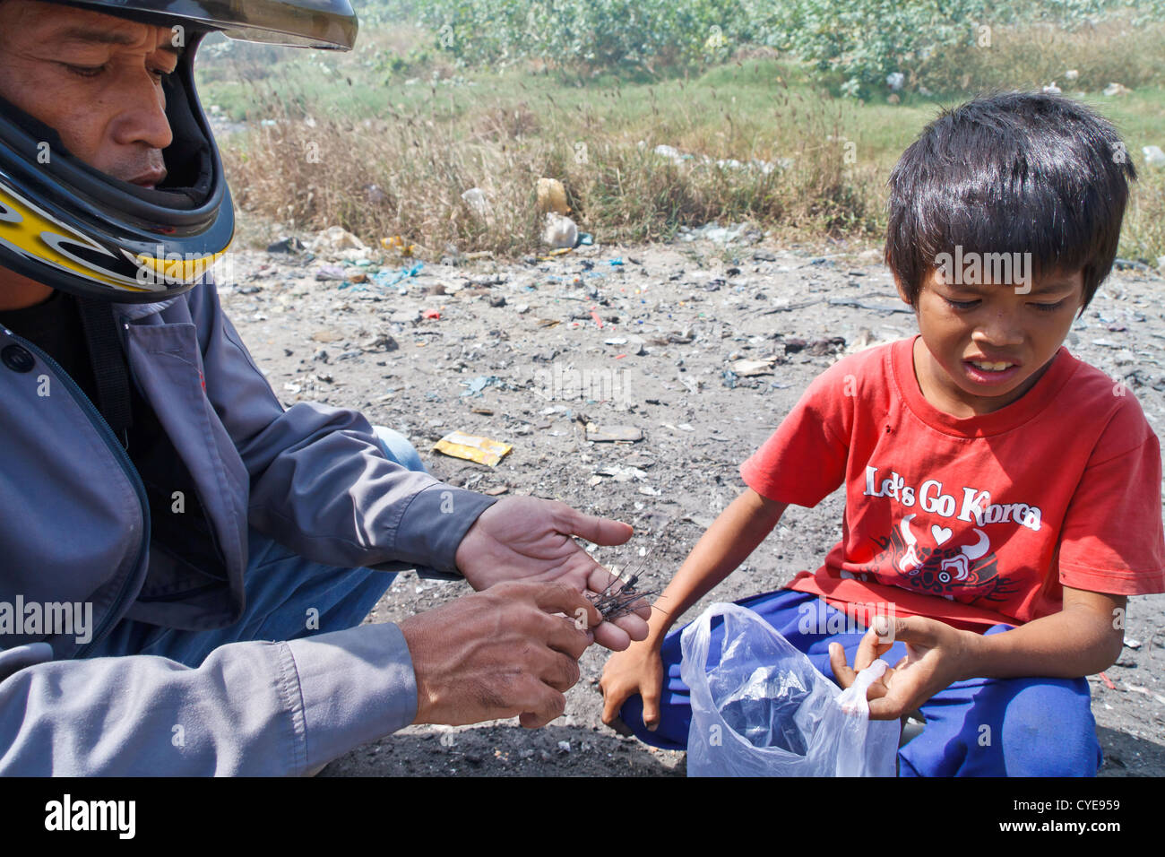 Scavenger Boys searching for electronic Parts on the Dump Site at Stung Meanchey in Phnom Penh, Cambodia Stock Photo