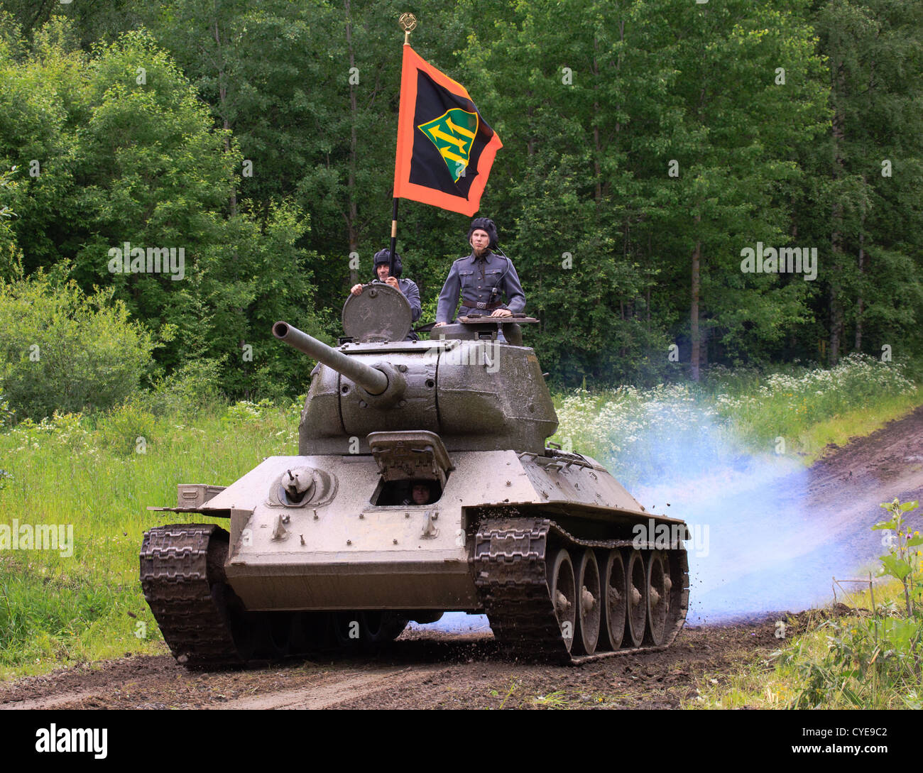 WW2 historic Soviet T-34 tank captured in combat by the Finns in parade with the Armored Division flag. Stock Photo