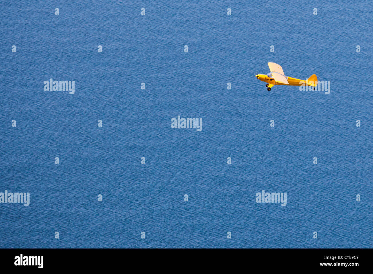 The Netherlands, Scheveningen, The Hague or in Dutch: Den Haag. Small airplane, a Piper Cub, flying over the North Sea. Aerial. Stock Photo