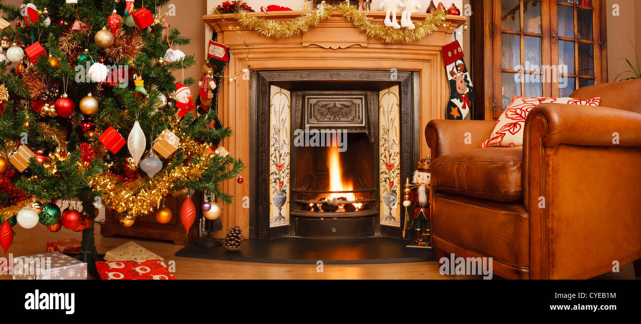 Christmas interior fire place in a living room in panoramic format Stock Photo