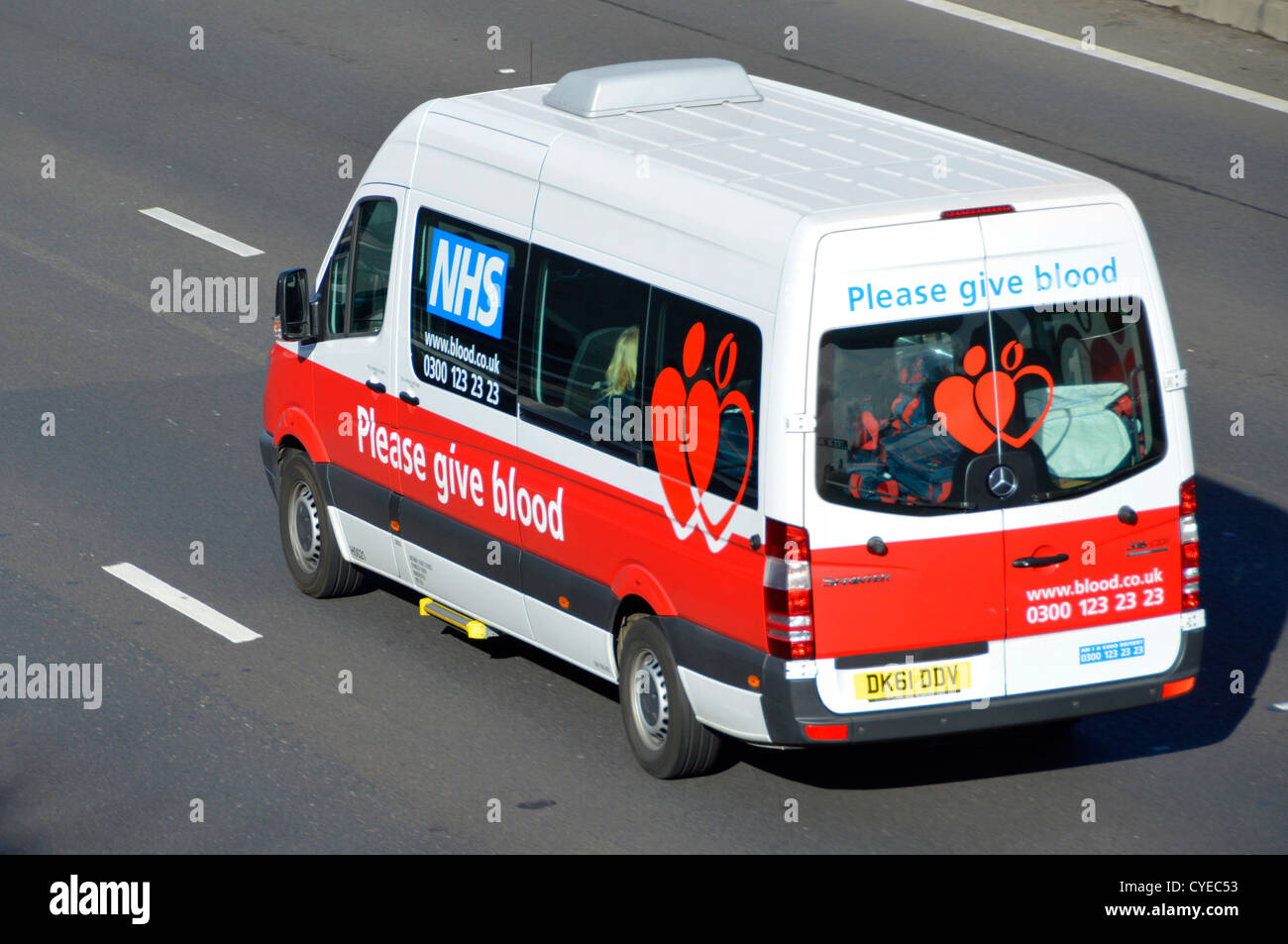 NHS blood donor team mini bus on motorway Stock Photo