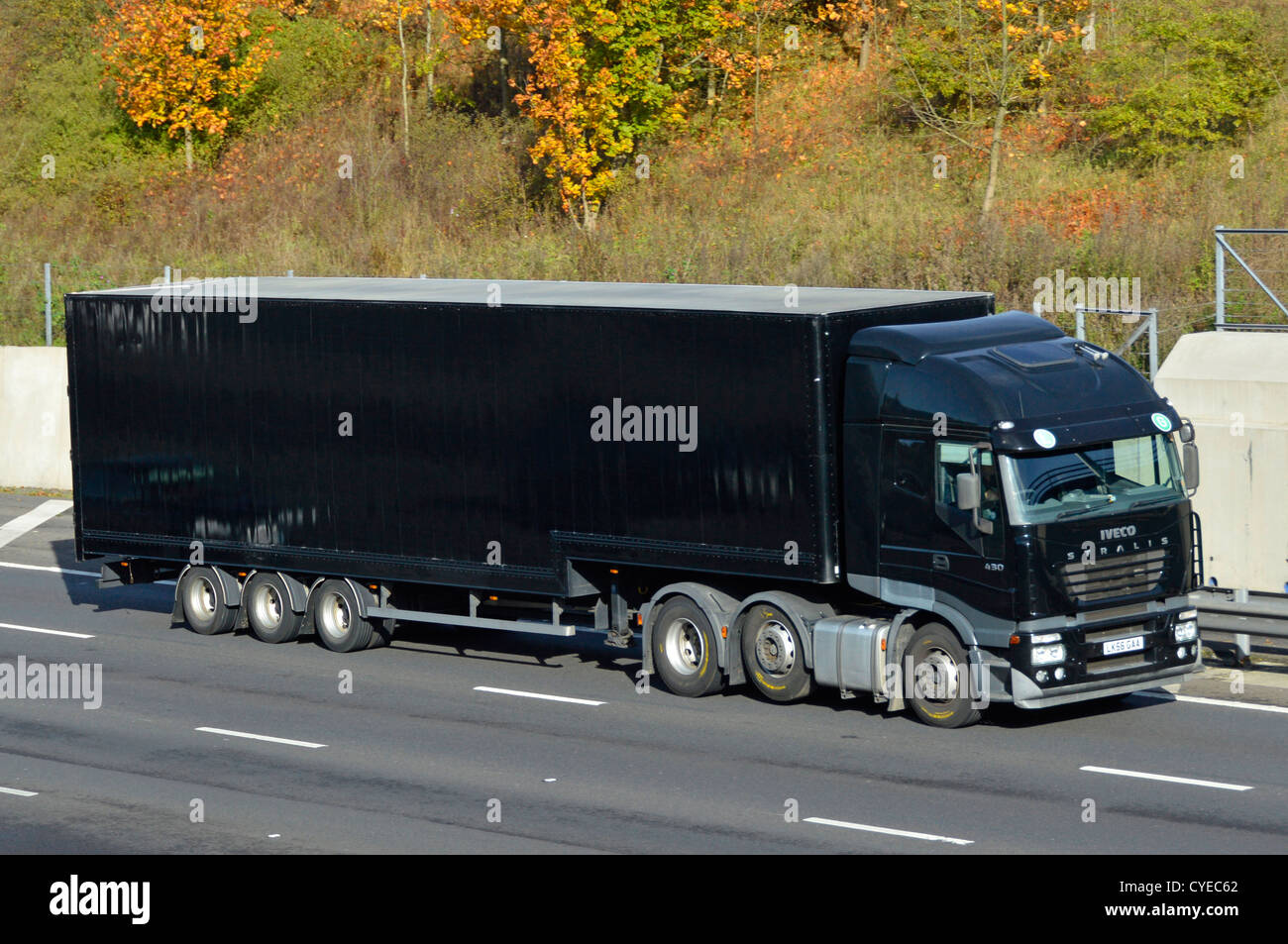 black-unmarked-articulated-iveco-lorry-and-trailer-on-motorway-CYEC62.jpg