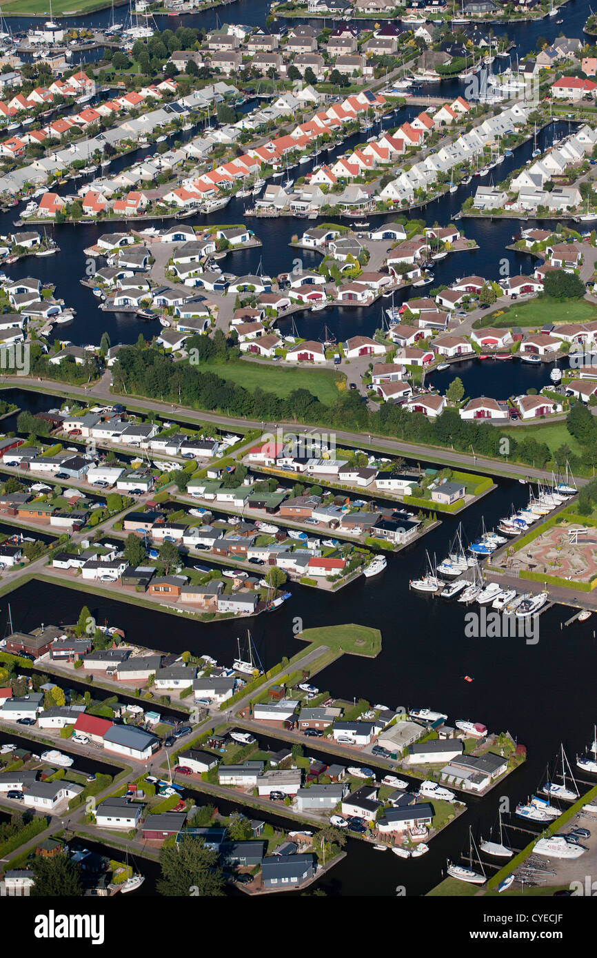 The Netherlands, Lemmer, Aerial. Holiday houses at waterside. Stock Photo