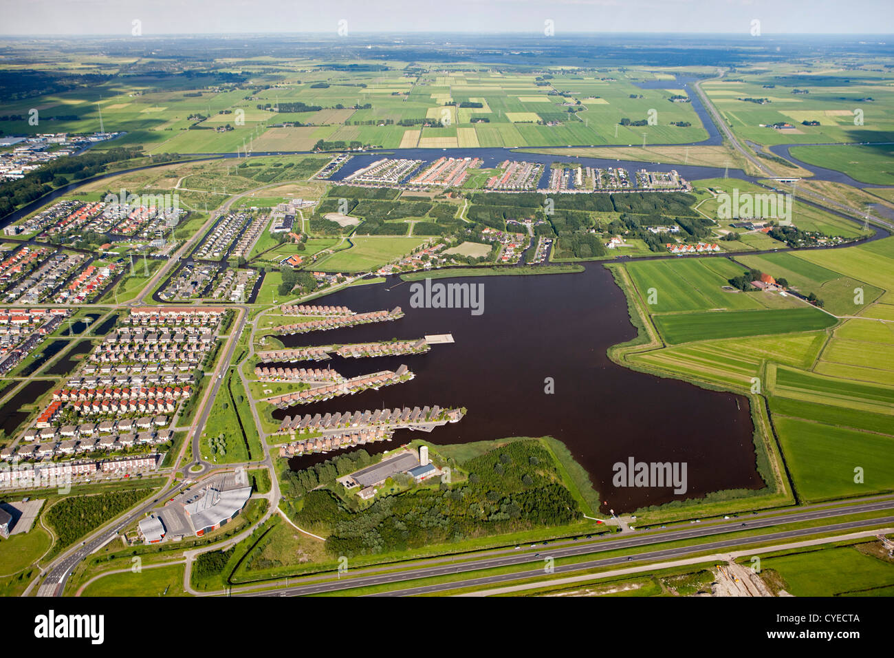 The Netherlands, Leeuwarden, Aerial. Residential district at lake called Tearnzer Wielen. Stock Photo