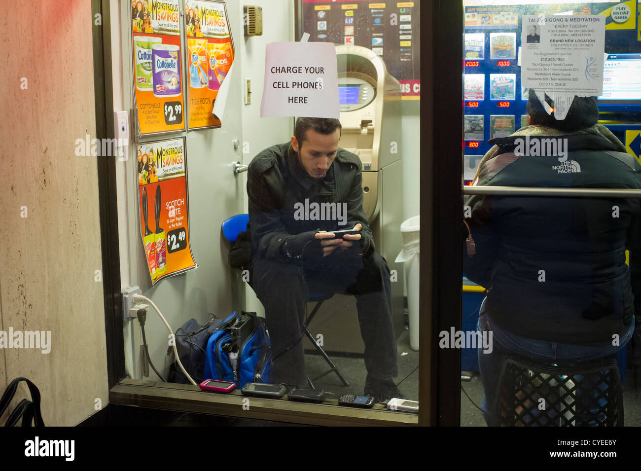 People charging their cell phones in Chelsea in New York Stock Photo