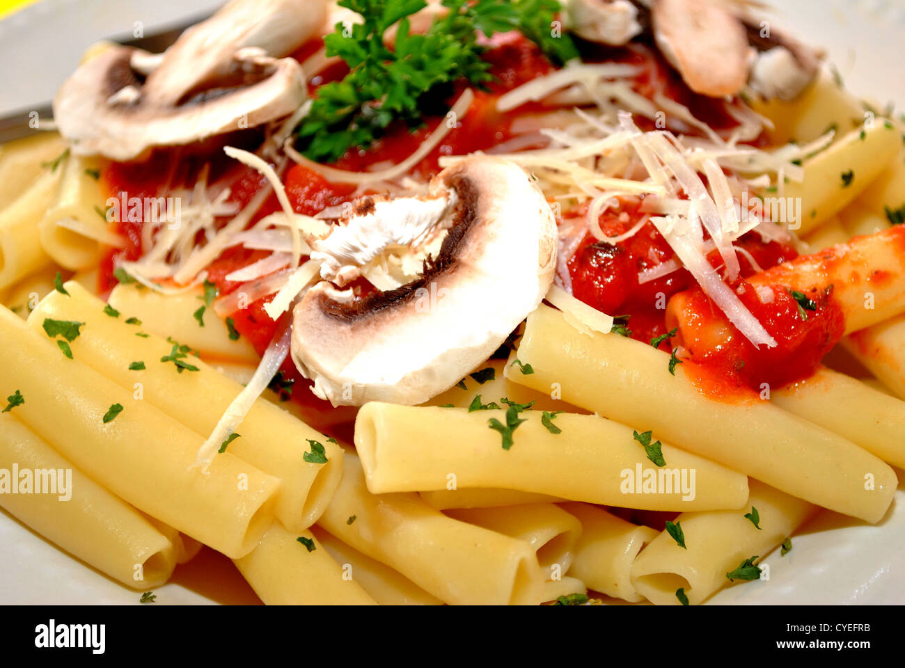 Close-Up of Pasta with Cheese, Sauce, and Mushrooms. Stock Photo