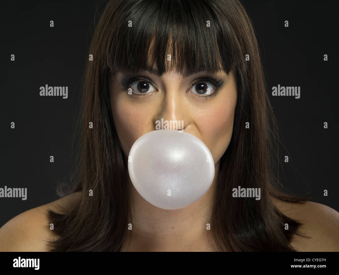 Girl blowing a bubble with pink bubble gum Stock Photo
