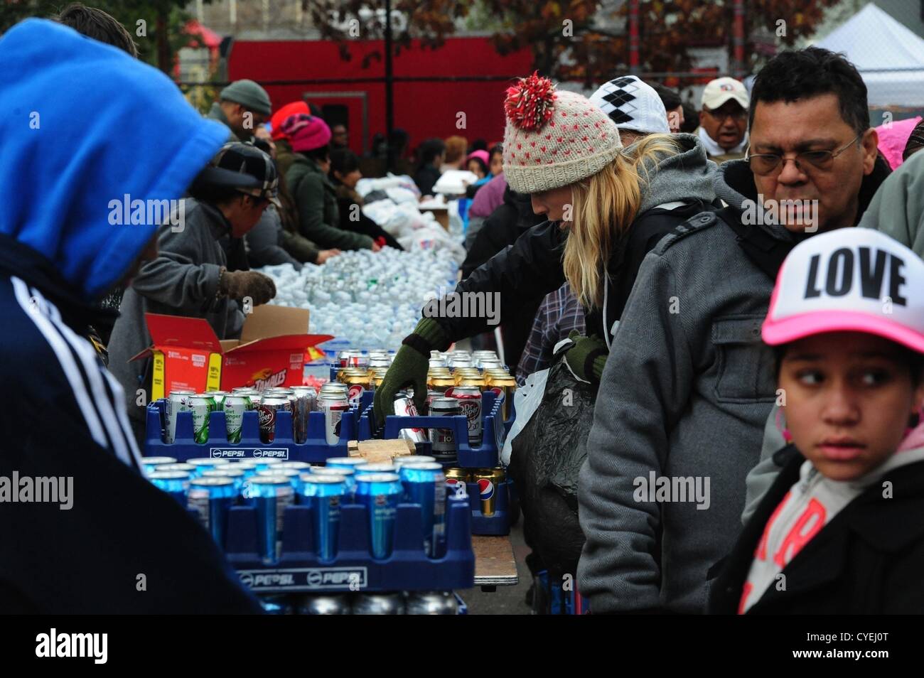 Nov. 2, 2012 - Manhattan, New York, U.S. - Members of the Air National Guard Unit 105th out of Stewart Air Force Base with community volunteers deliver and distribute food, water, toiletries, cleaning supplies and other goods to residents in the East Village at a distribution center at Vladic Palyground on East 10th Street between Avenue C and Avenue D near the ConEd plant on East 14th Street this afternoon following the effects of Hurricane Sandy in New York, November 2, 2012. (Credit Image: © Bryan Smith/ZUMAPRESS.com) Stock Photo