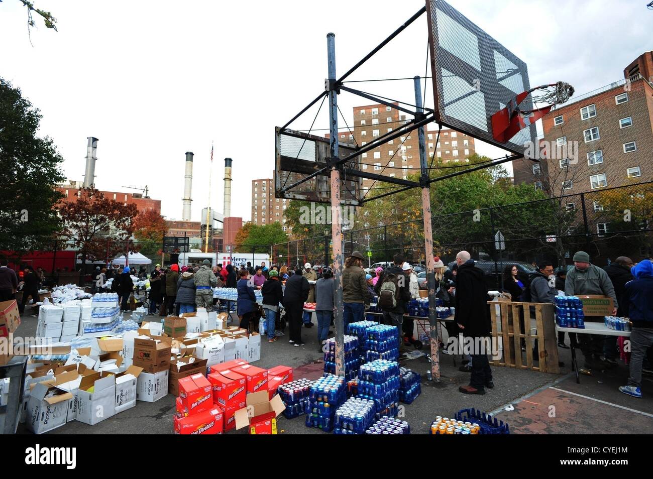 Nov. 2, 2012 - Manhattan, New York, U.S. - Members of the Air National Guard Unit 105th out of Stewart Air Force Base with community volunteers deliver and distribute food, water, toiletries, cleaning supplies and other goods to residents in the East Village at a distribution center at Vladic Palyground on East 10th Street between Avenue C and Avenue D near the ConEd plant on East 14th Street this afternoon following the effects of Hurricane Sandy in New York, November 2, 2012. (Credit Image: © Bryan Smith/ZUMAPRESS.com) Stock Photo