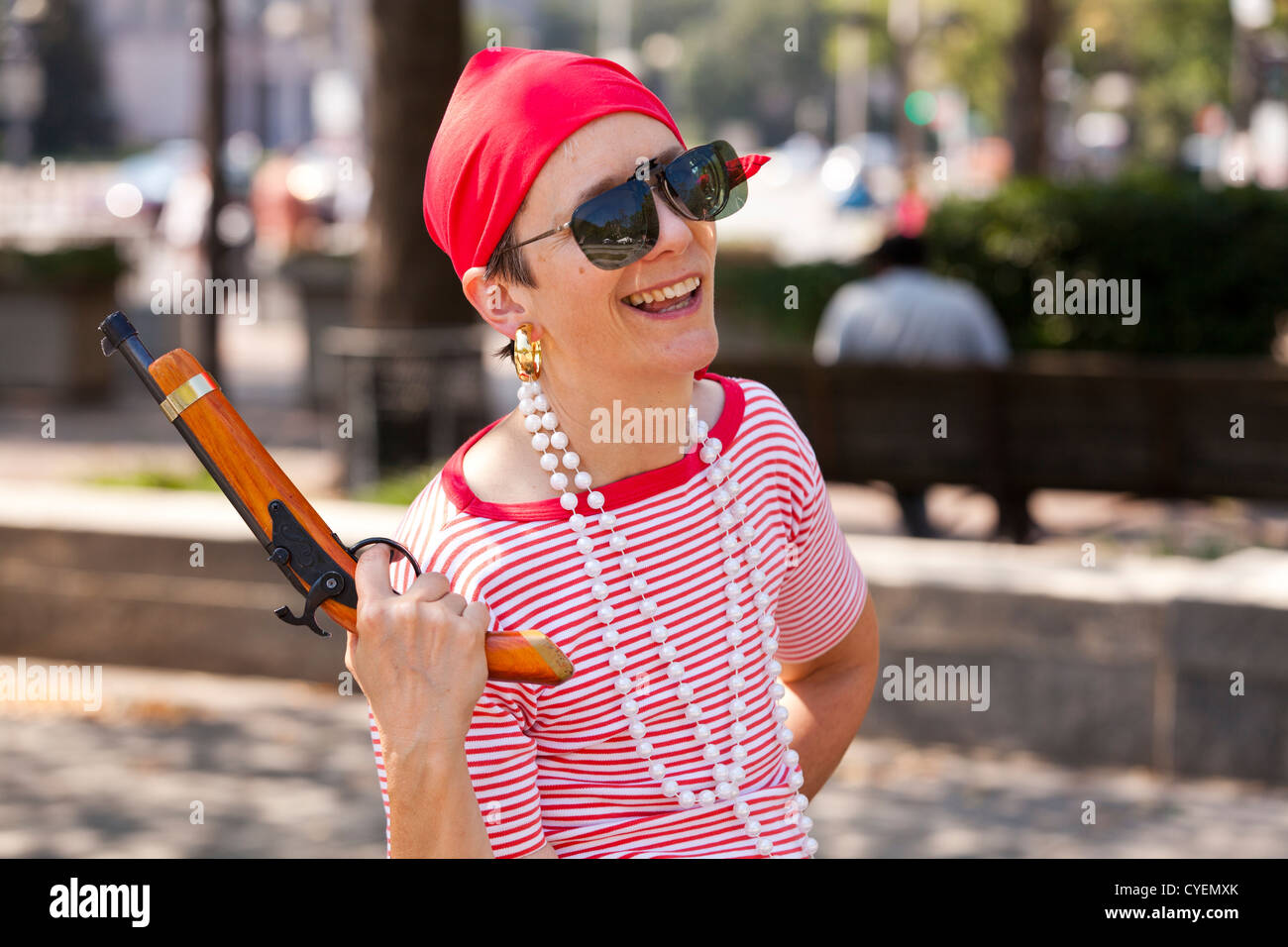 Woman dressed as a pirate holding a flintlock pistol Stock Photo