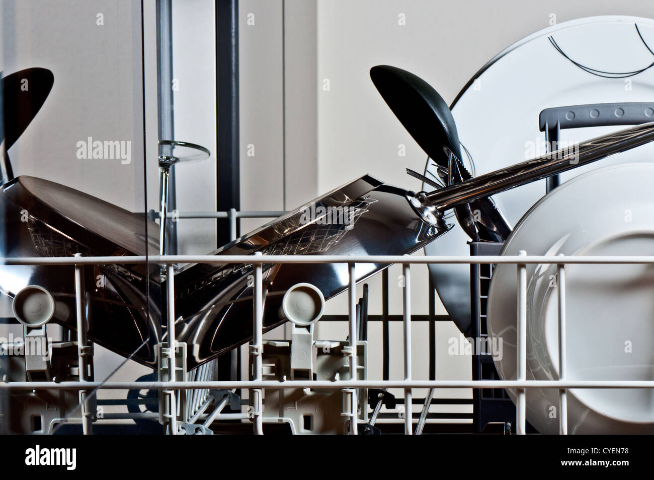 Dishes insid dishwasher next to stove Stock Photo Alamy