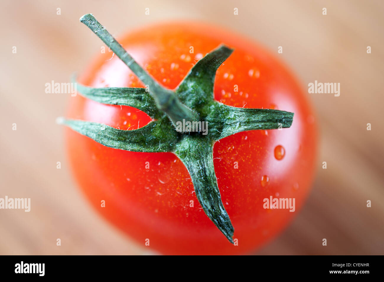 Red cherry tomato on a cutting board Stock Photo - Alamy