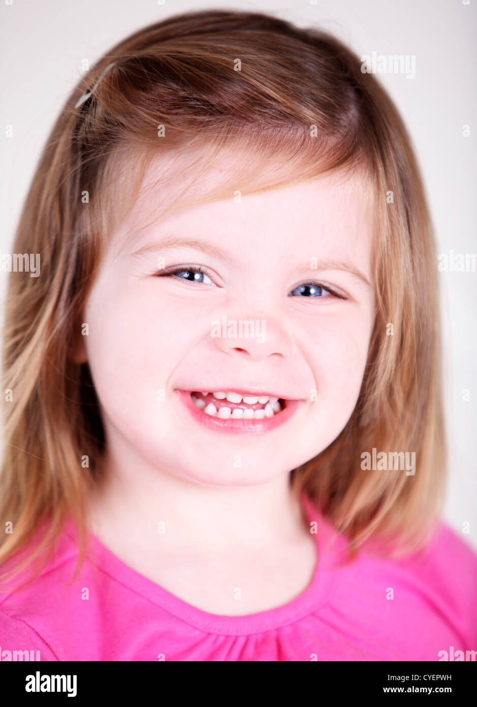 Pretty Toddler girl laughing in studio Stock Photo