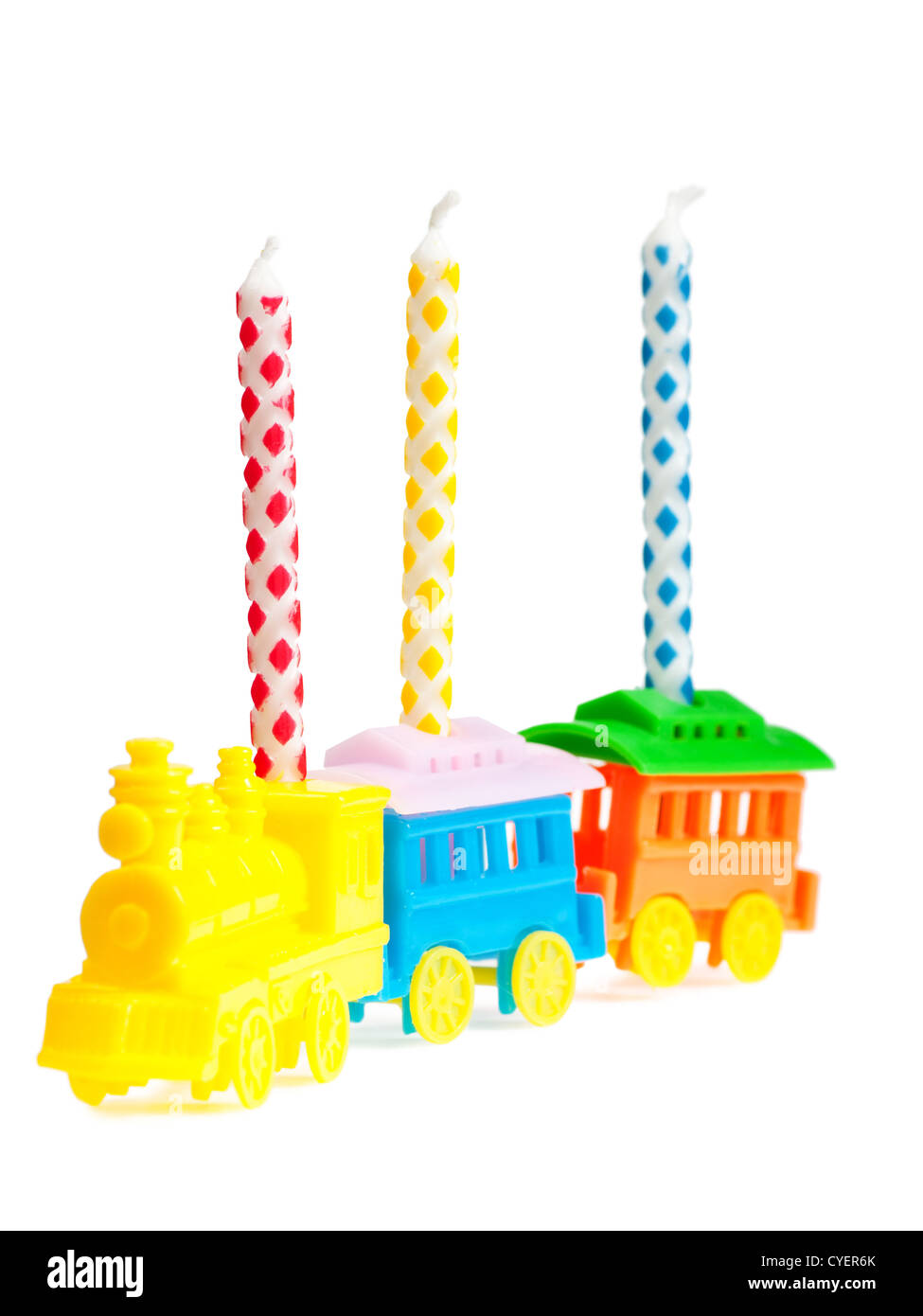 Macro view of three birthday candles in a train-shaped support Stock Photo