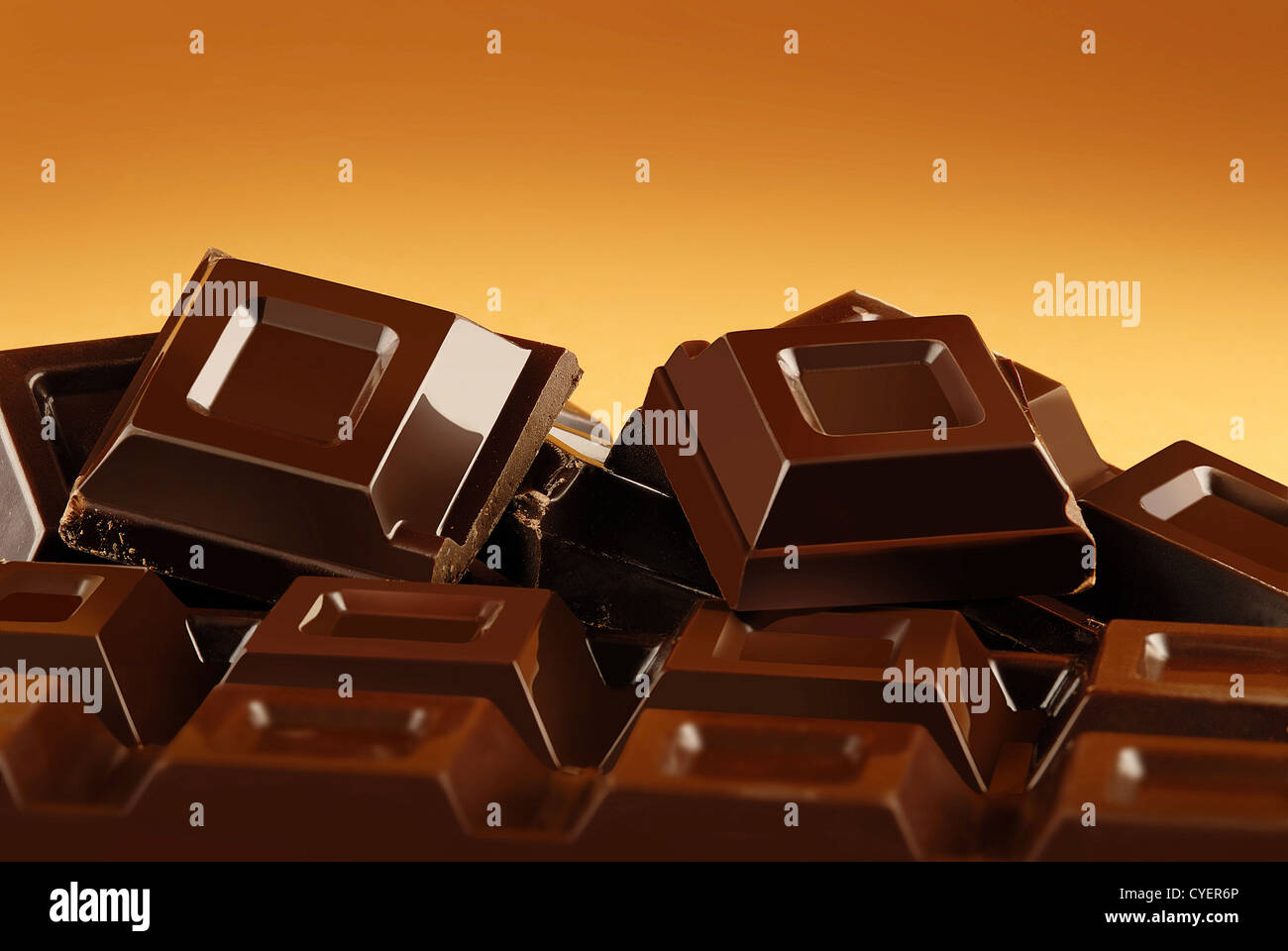 Broken chocolate bar on a brown background Stock Photo