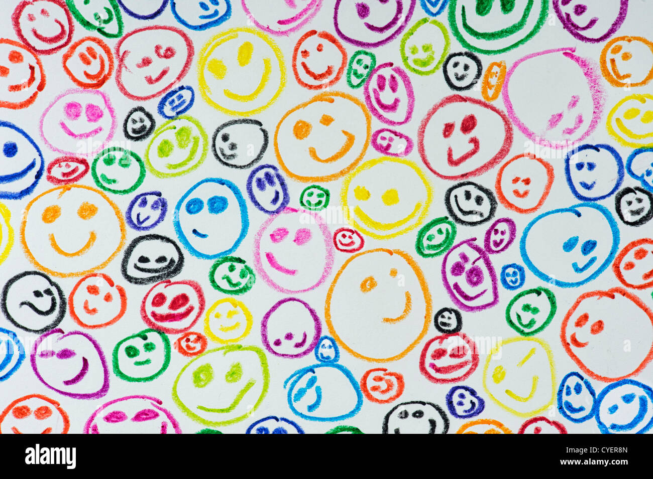 Childs wax crayon coloured drawing of happy smiling faces Stock Photo