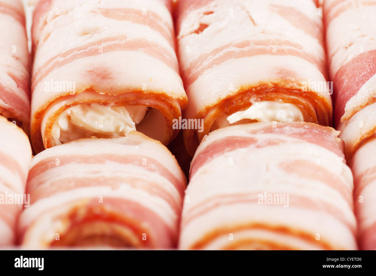Closeup view of group of bacon rolls with filling Stock Photo - Alamy