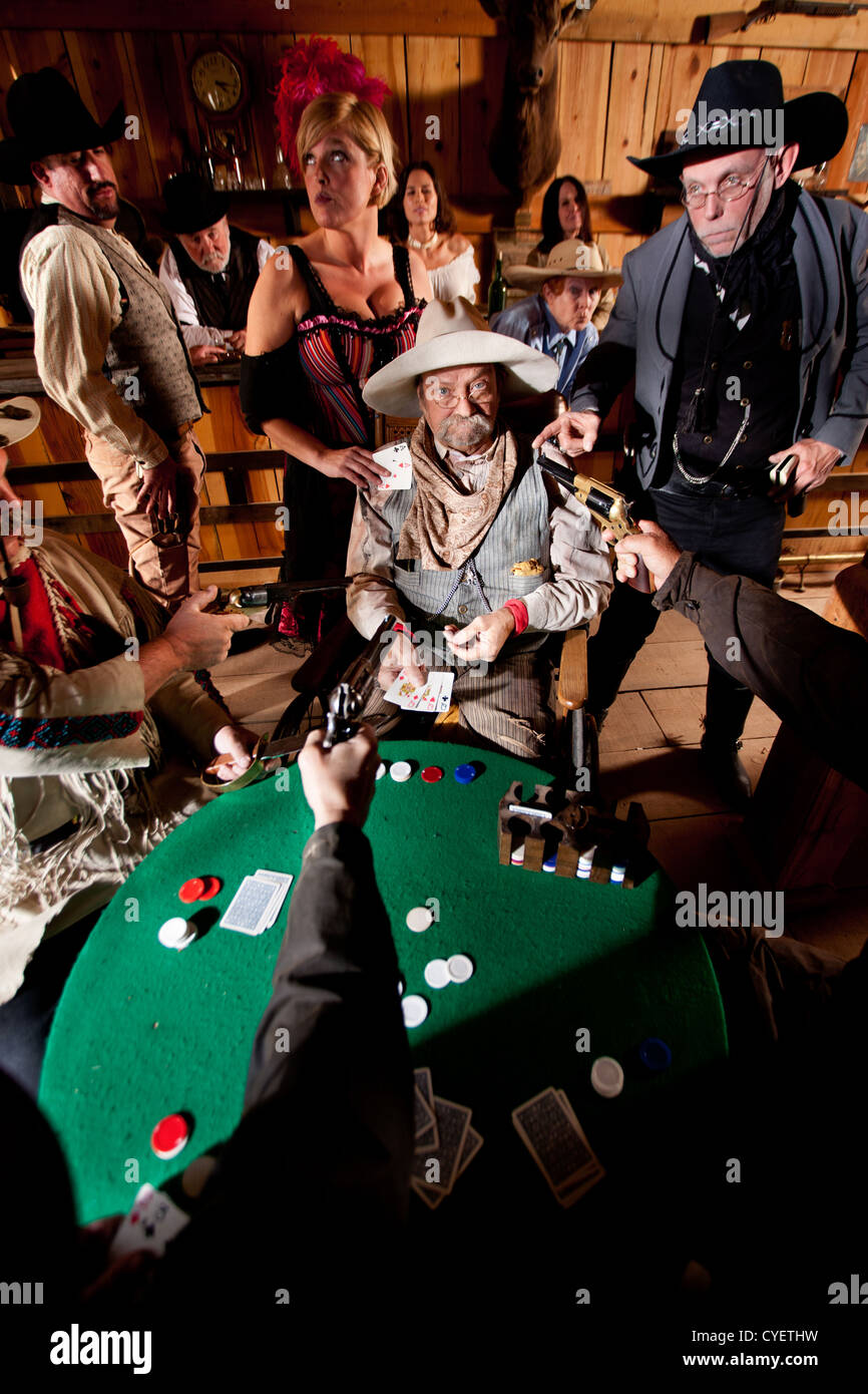An old western cowboy is caught cheating at cards by the entire saloon  Stock Photo - Alamy