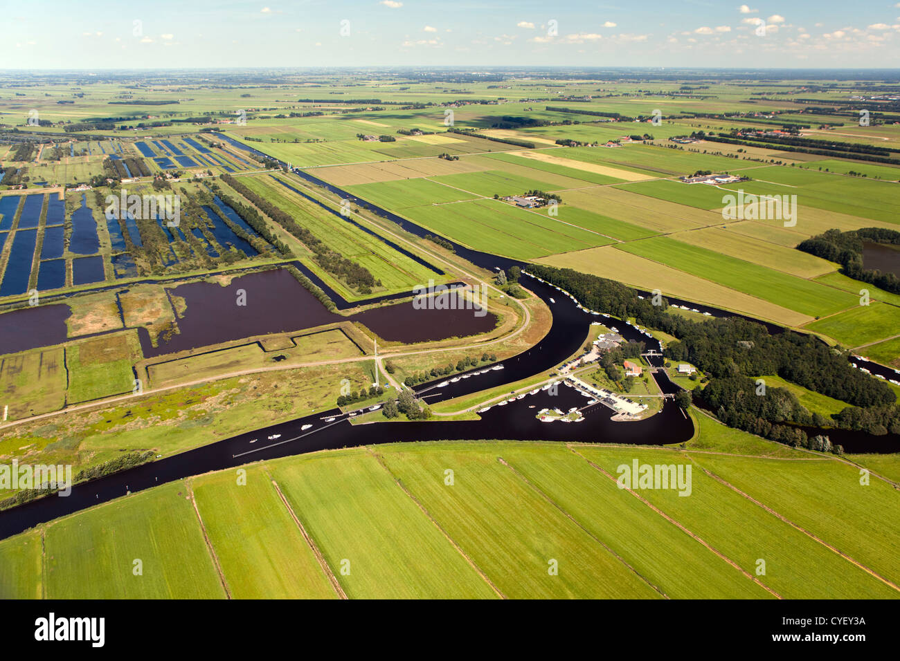 The Netherlands, Nijetrijne, Nature reserve called Rottige Meente and farmland. Small boats in marina. Aerial. Stock Photo