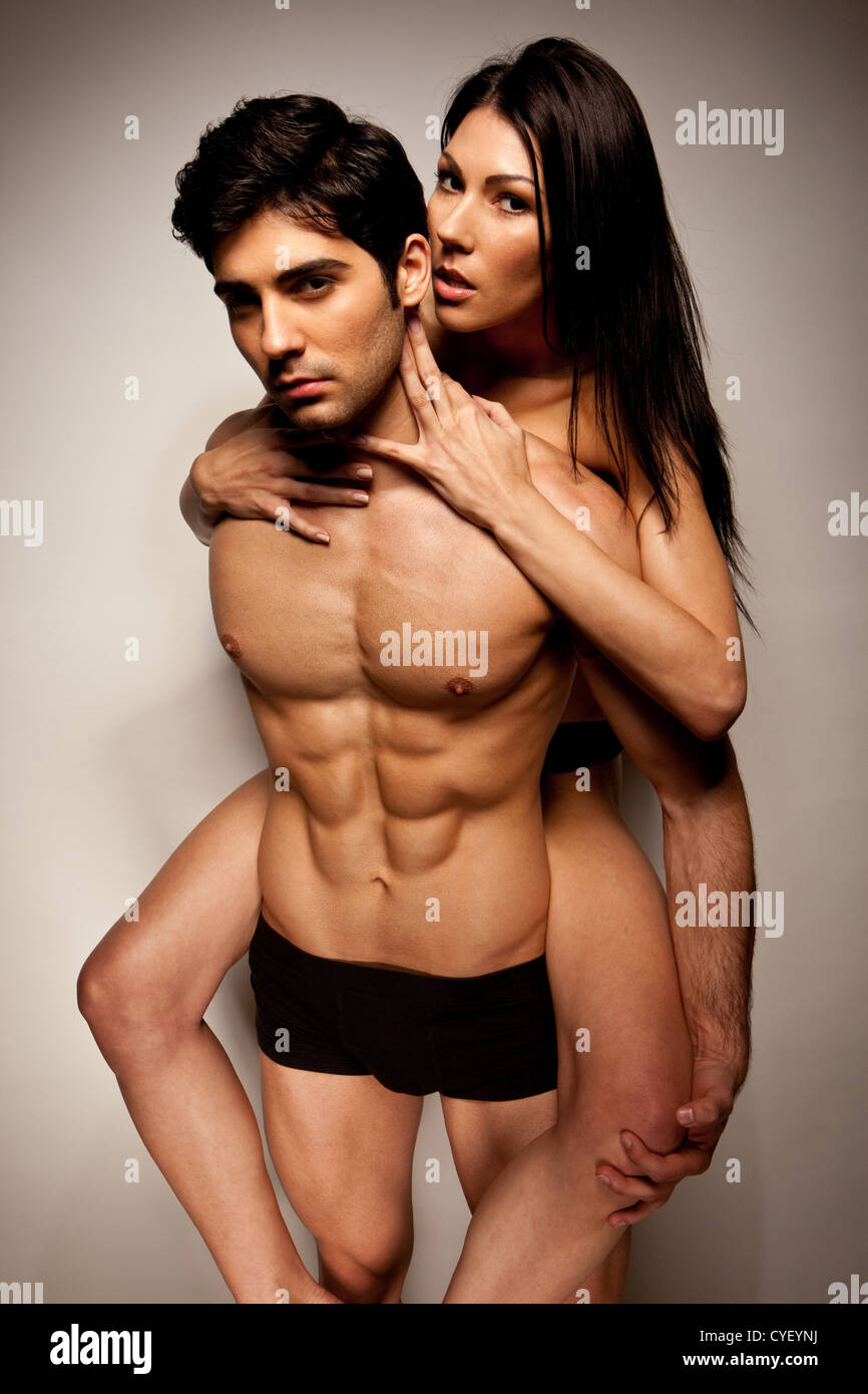 Sexy Woman Riding Piggyback on the back of a handsome young man in  underwear during foreplay Stock Photo - Alamy